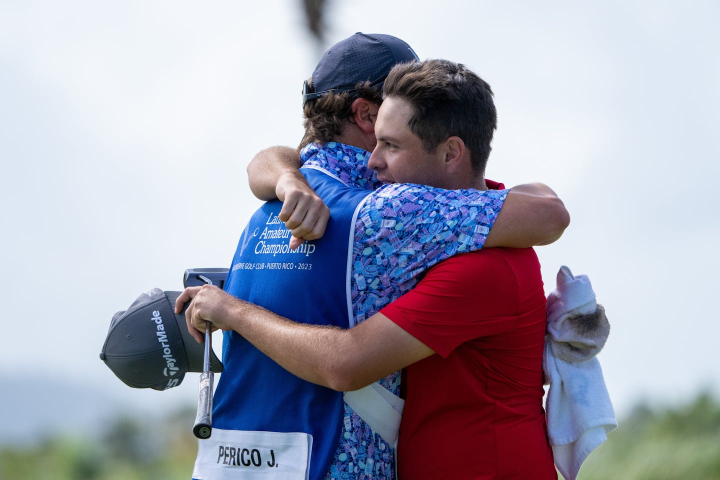 Julian Perico of Peru hugs his caddie on the No.18 green - Round 2