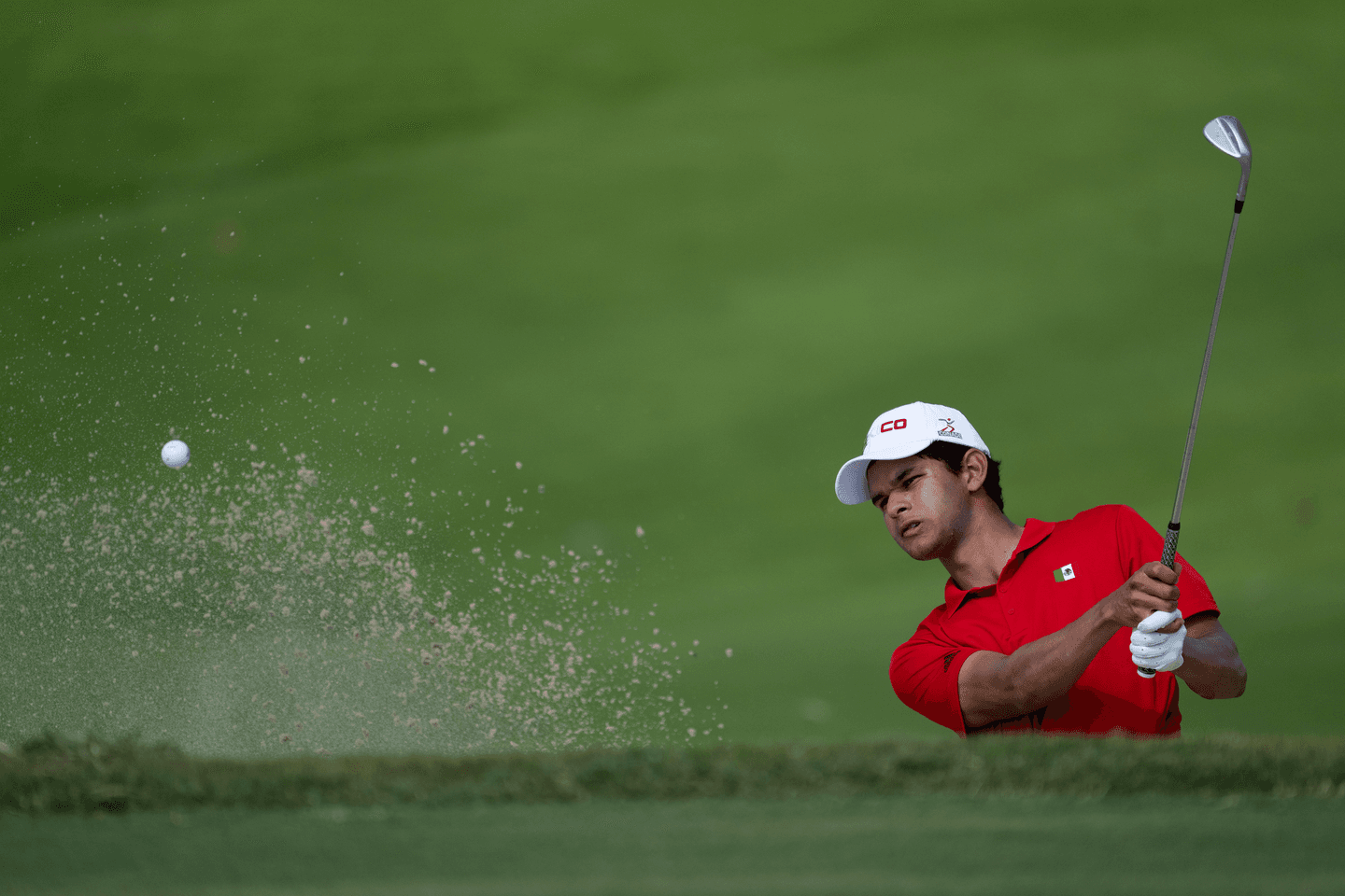 Omar Morales of Mexico plays a stroke from a bunker on the No. 6 hole.