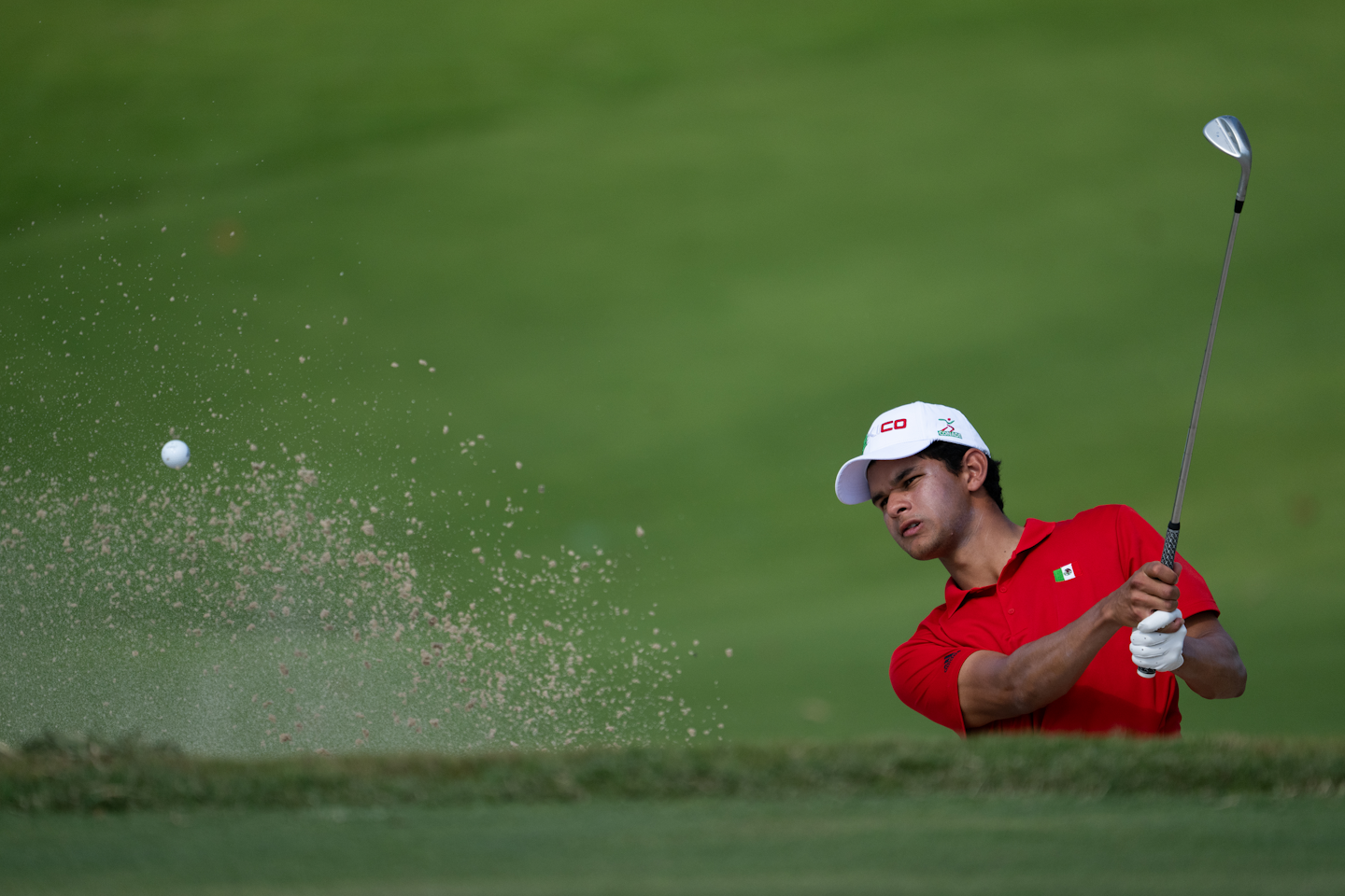 Omar Morales of Mexico plays a stroke from a bunker on the No. 6 hole.