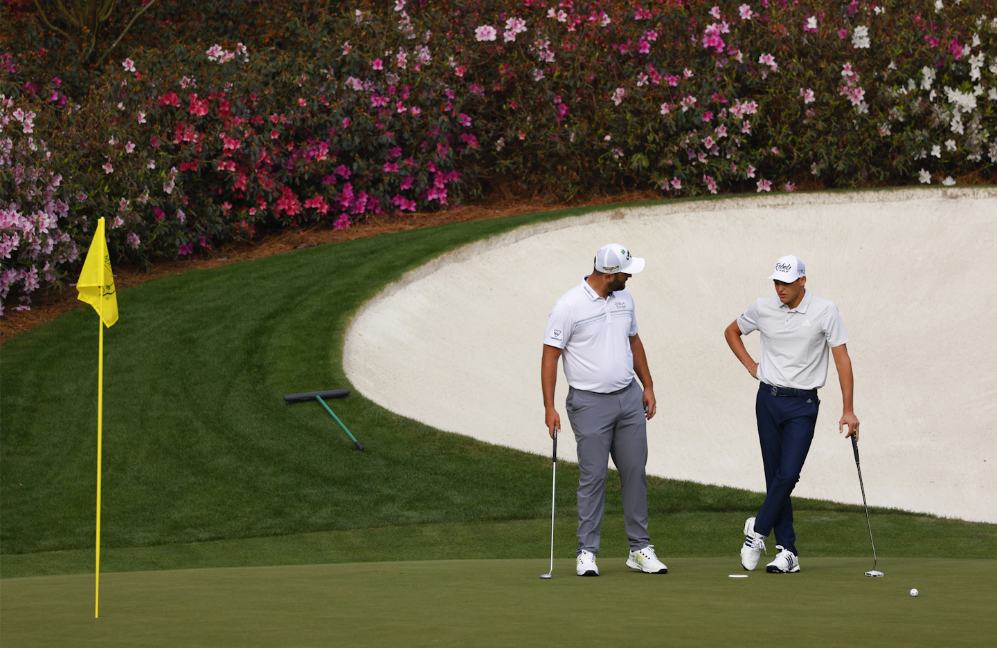 Amateur Aaron Jarvis of Cayman Islands (R) and Jon Rahm of Spain (L) talk on the No. 13 hole during practice round 2 for the Masters at Augusta National Golf Club, Tuesday, April 5, 2022.