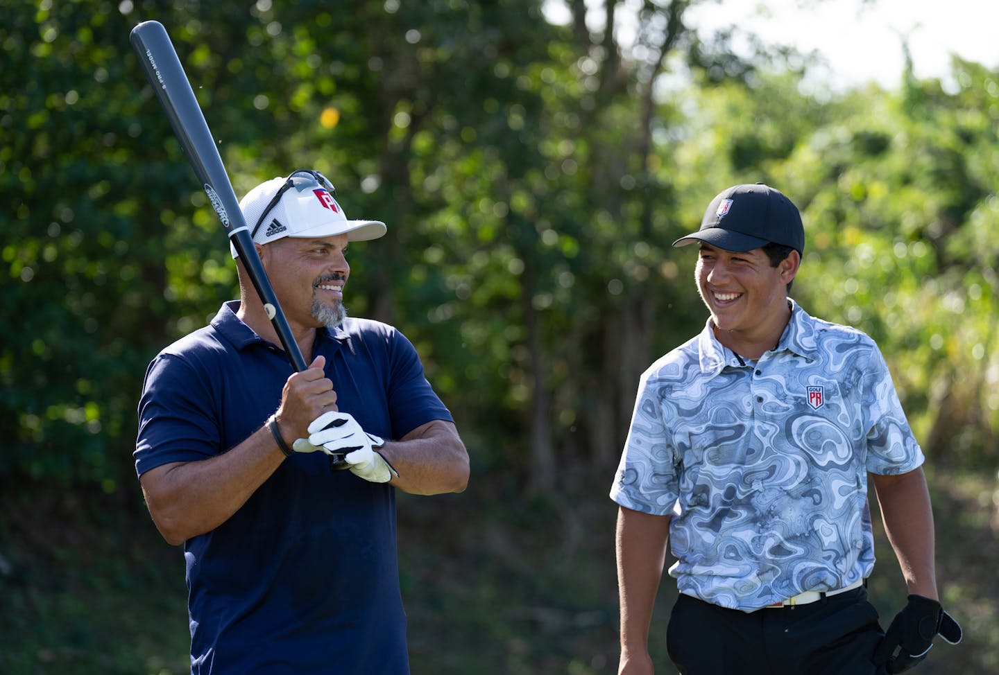 Iván "Pudge" Rodríguez, former MLB player, and Kelvin Hernández take part in a golf and baseball "nearest to the pin" event